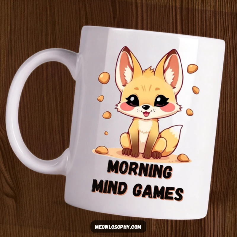 Funny mug featuring a playful fennec fox with a mischievous grin juggling small desert pebbles, conveying fun and skill.