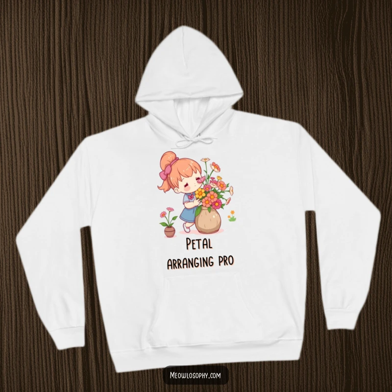 Funny cute character arranging fresh flowers in a rustic vase with care, featured on a warm and soft hoodie.