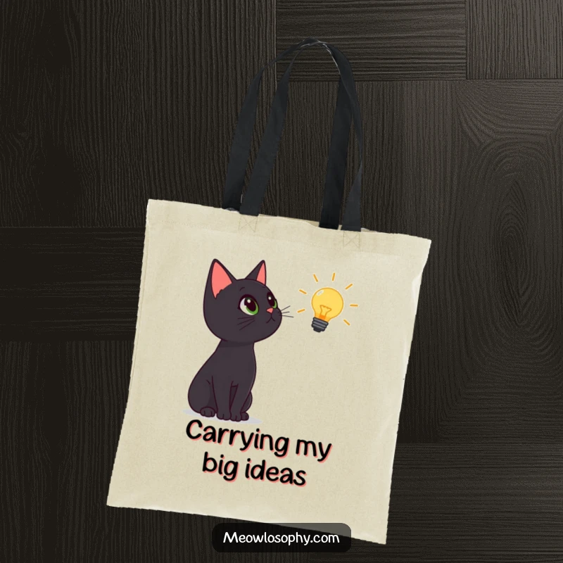 Funny black cat tote bag, cat gazing up at a lightbulb icon, symbolizes wisdom and curiosity, practical and humorous gift.